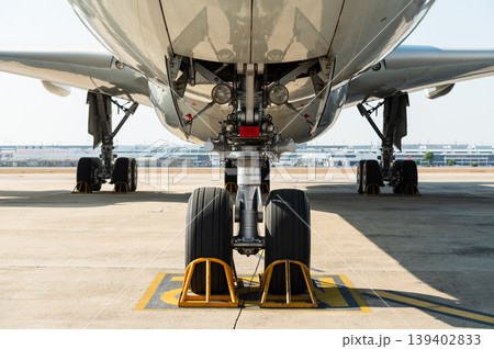 Front view of wide-body aircraft landing gear on tarmac 139402833