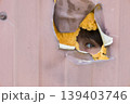 A Curious Gaze Looking Through a Hole in the Wall, Inspiring Wonder 139403746
