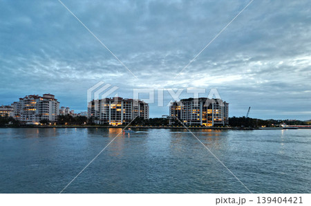 Fisher island night view. Night aerial view of Fisher island, Miami. Miami beach with waterfront architecture. Miami residential building, Florida. Fisher island. Travel destination 139404421