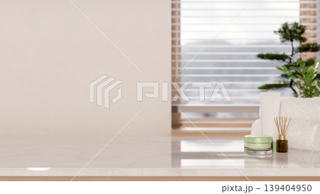 White towel with diffuser and cream jar on marble counter table across window blinds in modern room White towel with diffuser and cream jar on marble counter table across window blinds in modern room 139404950