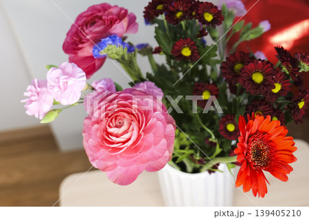 Vase of colorful flowers with a red heart balloon in the background, creating a bright Mothers Day composition. Vase of colorful flowers with a red heart balloon in the background, creating a bright Mothers Day composition. 139405210