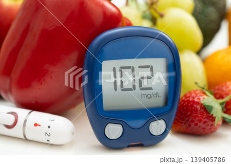 Digital glucose monitor measure with vegetable and fruit healthy food. Digital glucose monitor measure with vegetable and fruit healthy food. 139405786