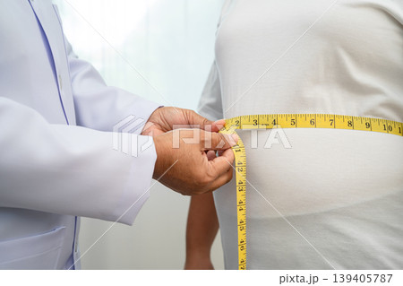 Asian woman with fat belly big size overweight and obesity with measure tape. Asian woman with fat belly big size overweight and obesity with measure tape. 139405787