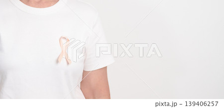 Elderly woman with Peach Ribbon for September Uterine Cancer Awareness month, Endometrial Cancer, Gynecologic, Uterus and Ovaries, Endometriosis, June Vaginal cancer and World cancer day concept 139406257