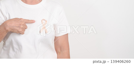 Elderly woman with Peach Ribbon for September Uterine Cancer Awareness month, Endometrial Cancer, Gynecologic, Uterus and Ovaries, Endometriosis, June Vaginal cancer and World cancer day concept 139406260