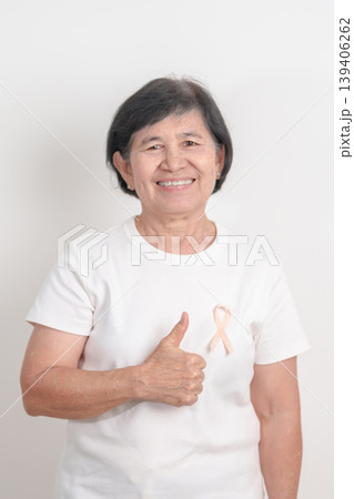 Elderly woman with Peach Ribbon for September Uterine Cancer Awareness month, Endometrial Cancer, Gynecologic, Uterus and Ovaries, Endometriosis, June Vaginal cancer and World cancer day concept 139406262