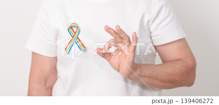 Elderly with LGBTQ Rainbow ribbon for concept of June Pride month, April Autism Awareness, All cancer Awareness, February World Cancer day, October World Hospice and Palliative care day and Survivor Elderly with LGBTQ Rainbow ribbon for concept of June Pride month, April Autism Awareness, All cancer Awareness, February World Cancer day, October World Hospice and Palliative care day and Survivor 139406272