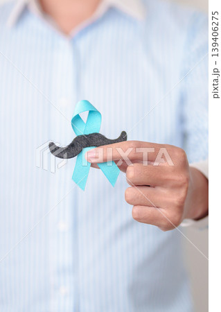 Man with blue Ribbon and mustache for Blue November, November Prostate Cancer Awareness month, World Diabetes day , Men Health month, June International men, Father day. Healthcare and world cancer 139406275