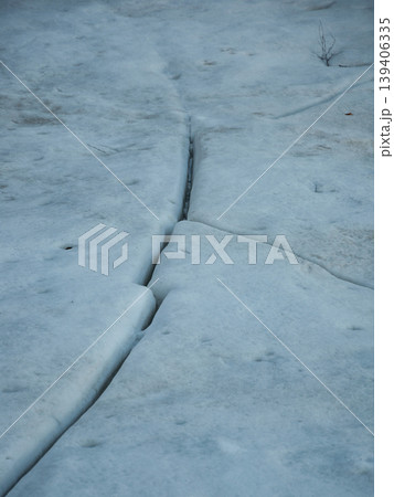 Cracks in lake ice in springtime in Finland Cracks in lake ice in springtime in Finland 139406335