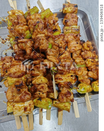 Traditional Japanese Yakitori Grilled Chicken Skewers with Green Onions on Metal Tray 139406918
