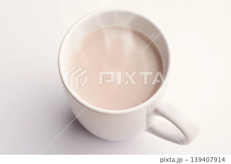 Hot cocoa with milk in cup on white table in kitchen 139407914