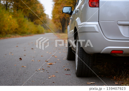 Silver car standing on the wayside in the countryside in Autumn 139407923