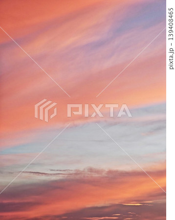 Beautiful evening sky with a soft gradient of orange, pink, and blue before sunset. 139408465
