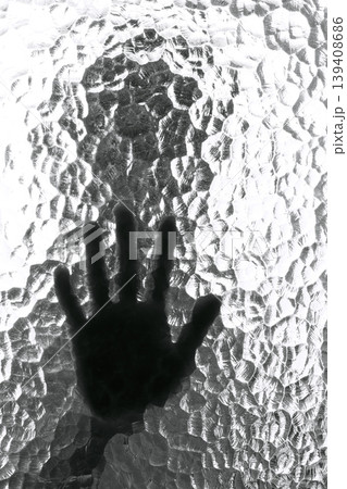 The silhouette of the person and its hand behind the door with the textured glass The silhouette of the person and its hand behind the door with the textured glass 139408686