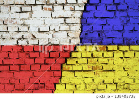 Flags of Poland and Ukraine on the brick wall with big crack in the middle. Symbol of problems between countries Flags of Poland and Ukraine on the brick wall with big crack in the middle. Symbol of problems between countries 139408738