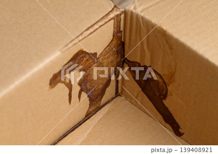 Leakage damage to cardboard parcel box close up 139408921