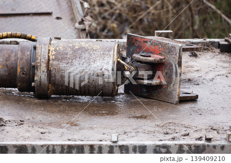 A close-up of a rusted hydraulic cylinder and clevis joint A close-up of a rusted hydraulic cylinder and clevis joint 139409210