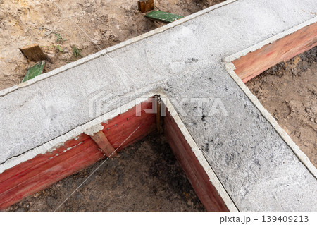 Concrete footing and wooden formwork on residential construction site 139409213