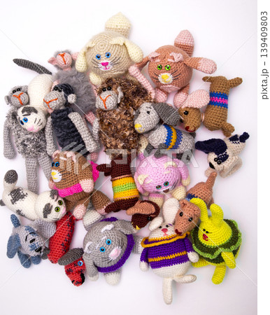 Various knitted woolen toys on a white background 139409803