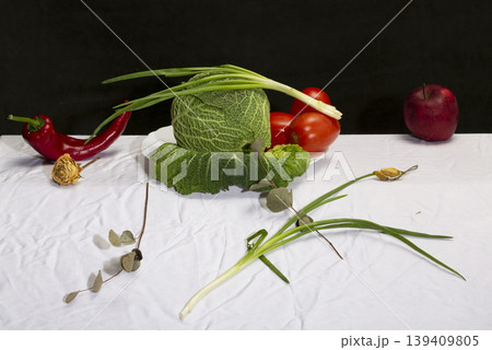 Still life with Savoy cabbage, vegetables and fruits on a white tablecloth Still life with Savoy cabbage, vegetables and fruits on a white tablecloth 139409805