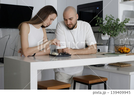 Closeup portrait of woman and man playing chess at home 139409945