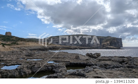 Panoramic view of the rocky coast with a small watchtower on the left 139411320