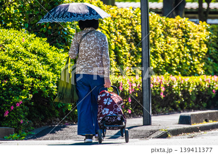 日本の横浜都市景観段差…日傘をさしてカートを引く高齢女性…段差や柱が… 日本の横浜都市景観段差…日傘をさしてカートを引く高齢女性…段差や柱が… 139411377