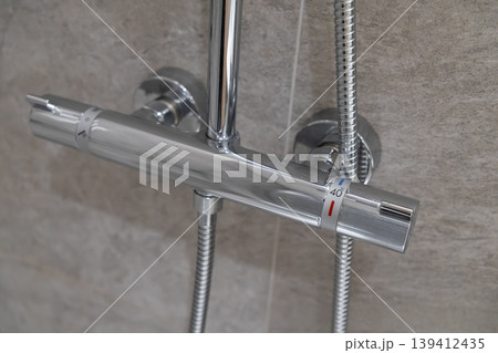 Sleek chrome thermostatic shower mixer with precise 40 degrees Celsius temperature control, crucial for modern bathroom comfort, safety, and efficient plumbing 139412435