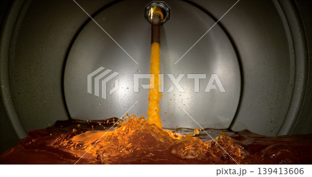 Gasoline jet pouring into metal fuel tank, inside view with dynamic splash and turbulence. Concept of refueling, fuel storage and energy supply, industrial environment. 139413606