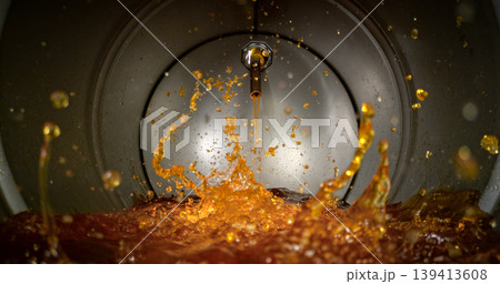 Gasoline jet pouring into metal fuel tank, inside view with dynamic splash and turbulence. Concept of refueling, fuel storage and energy supply, industrial environment. 139413608