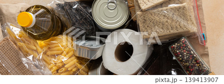 Canned goods, cereals, and pasta stored for quarantine and isolation, ensuring long-term survival and food security at home, survival during military operations, the concept of stay at home, banner 139413907