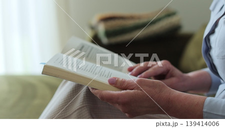 Elderly woman reading the book at home, close-up. Elderly woman reading the book at home, close-up. 139414006