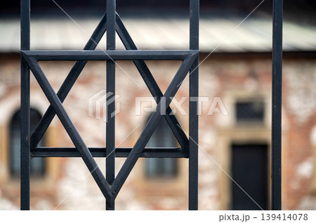 Star of David symbol seen through metal bars in historical setting Star of David symbol seen through metal bars in historical setting 139414078