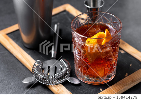 Old Fashioned Cocktail with Orange Peel on black background Old Fashioned Cocktail with Orange Peel on black background 139414279