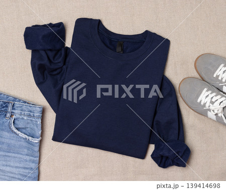 Navy blue unisex sweatshirt mockup, folded flat lay with denim shorts and grey sneakers, top view 139414698