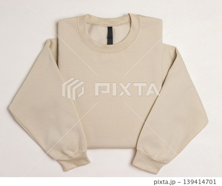 Blank beige unisex sweatshirt mockup, folded apparel template, copy space on front and sleeves Blank beige unisex sweatshirt mockup, folded apparel template, copy space on front and sleeves 139414701