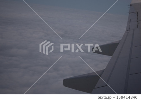 View from airplane window. Airplane wing over clouds View from airplane window. Airplane wing over clouds 139414840