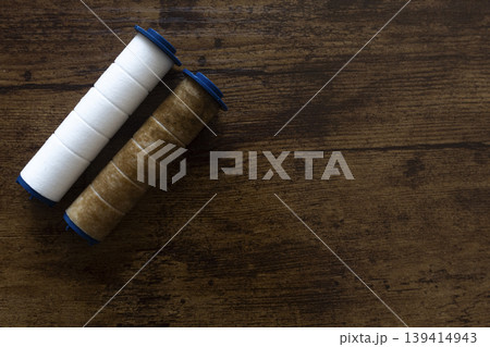 New and used water filter cartridges on wooden background with copy space 139414943