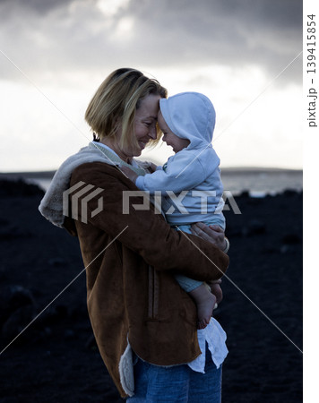 Authentic moment of love and connection between mother and toddler near the sea Authentic moment of love and connection between mother and toddler near the sea 139415854