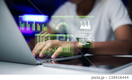 Environmental social and governance holographic interface for corporate report,Business professional analyzing ESG sustainability data on laptop,Workspace with ESG dashboard for investment strategy. 139416444