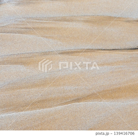 Rhythmic sand ripples create a hypnotic geometric pattern. Parallel lines and soft shadows enhance the tactile organic texture of this minimalist desert landscape view Rhythmic sand ripples create a hypnotic geometric pattern. Parallel lines and soft shadows enhance the tactile organic texture of this minimalist desert landscape view 139416706