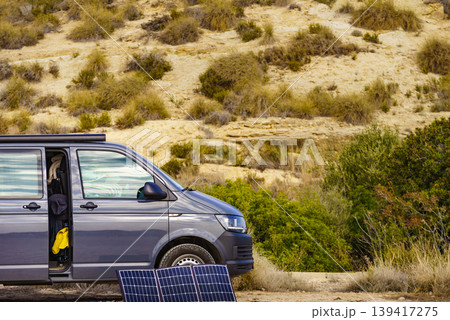 Portable solar photovoltaic panel, charging battery at camper van vehicle. Portable solar photovoltaic panel, charging battery at camper van vehicle. 139417275