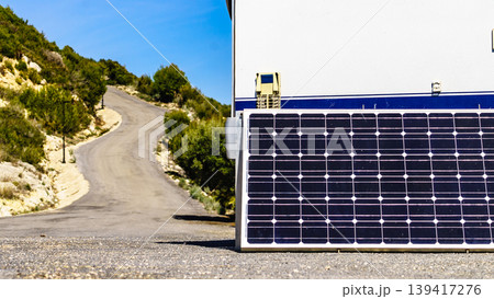 Portable solar photovoltaic panel, charging battery at camper vehicle. 139417276