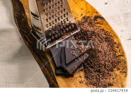 Grater and grated chocolate closeup Grater and grated chocolate closeup 139417439