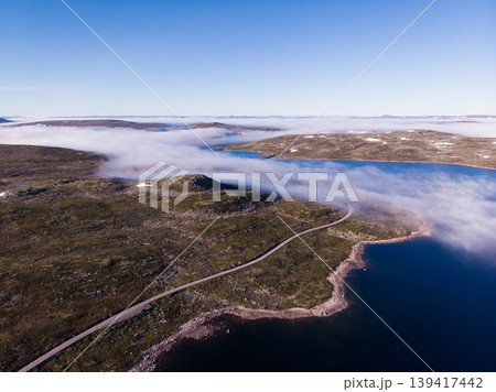 Road crossing Hardangervidda plateau, Norway. Aerial view. Road crossing Hardangervidda plateau, Norway. Aerial view. 139417442