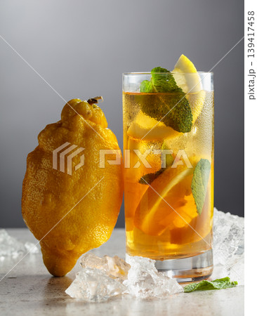 Iced tea in a misted glass on a stone table. Iced tea in a misted glass on a stone table. 139417458