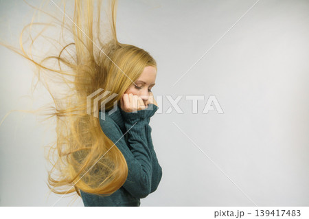 Sad girl with blowing hair 139417483
