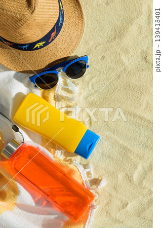 Beach Essentials with Hat, Sunglasses, Sunscreen and Water Bottle. Summer Vacation Flatlay 139418401