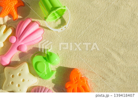 Colorful Beach Toys and Molds on Sand. Summer Fun and Outdoor Play FlatLay 139418407