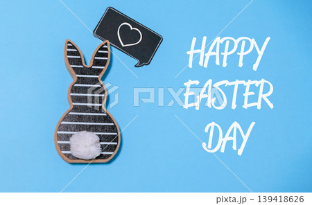 Rabbit is holding a heart and the words Happy Easter Day are written below it 139418626